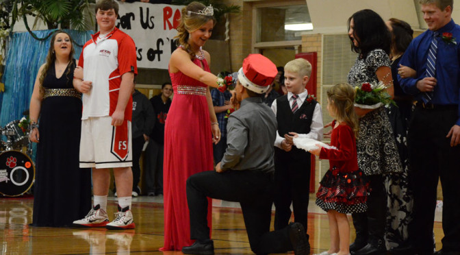 Homecoming royalty accept crowns while Tigers protect the court