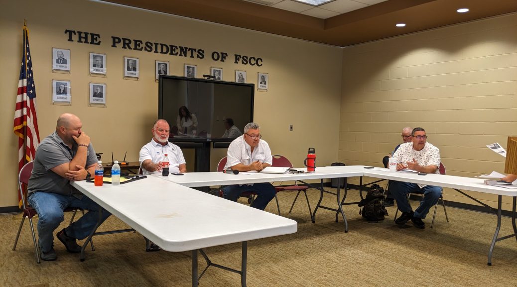 Bourbon County commissioners seated at tables during a budget town hall at Fort Scott Community College.
