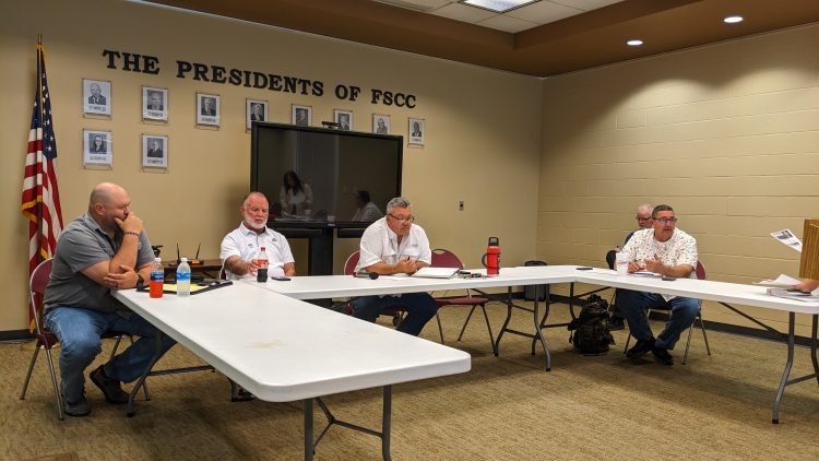 Bourbon County commissioners seated at tables during a budget town hall at Fort Scott Community College.